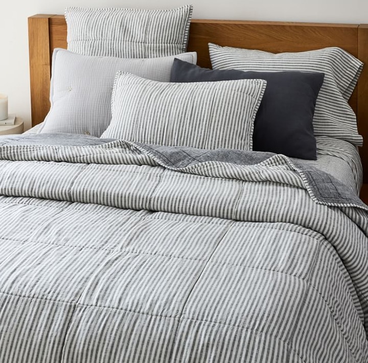 Bed with striped covers and pillows