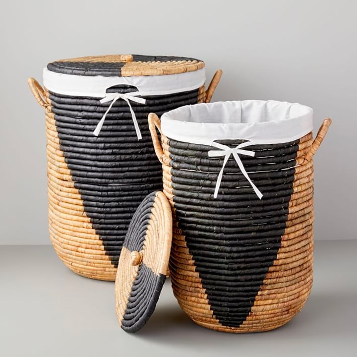 Black and woven lidded laundry hampers