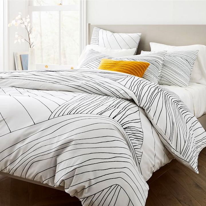 Bed with white and black striped duvet
