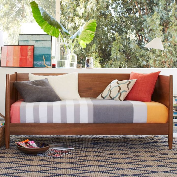Mid-century daybed with colorful striped mattress