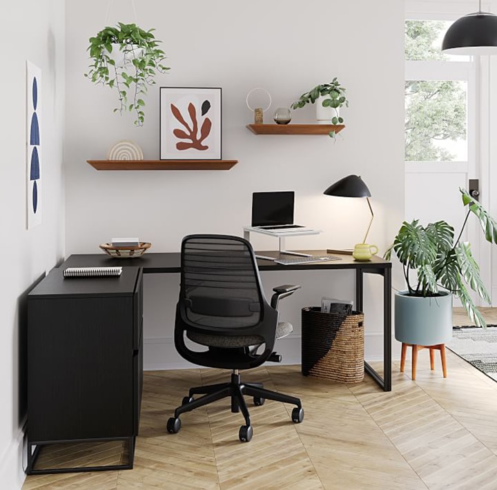 Black corner desk with plants