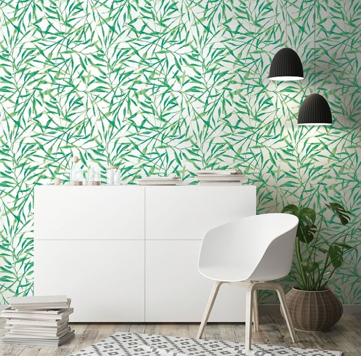 Modern furniture in front of wallpaper with green leaves