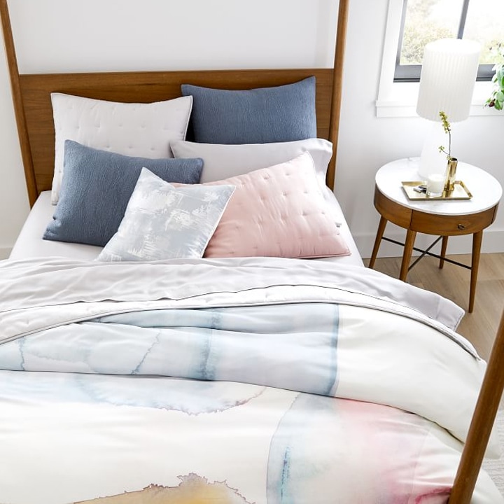 watercolor TENCEL™ bedding on mid-century bed frame