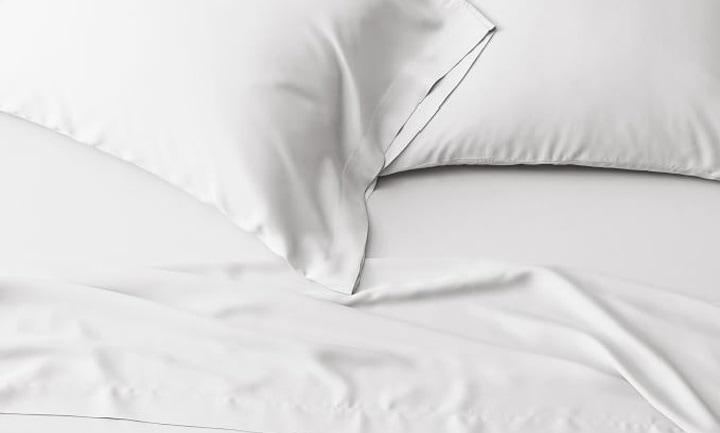close up of made bed with white TENCEL™ sheets