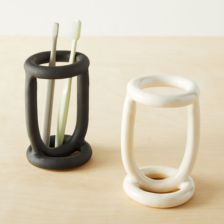 Two abstract toothbrush holders.