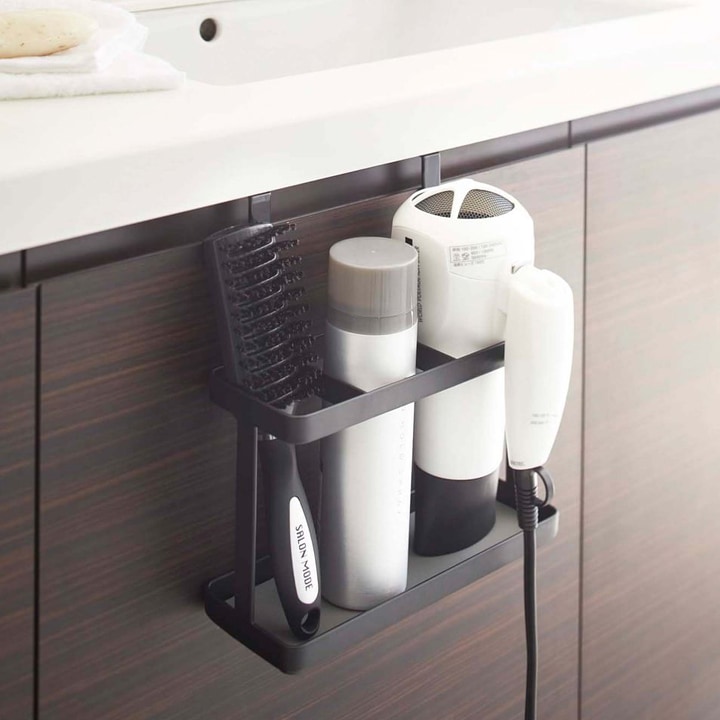 Over-cabinet organizer holding hair products.