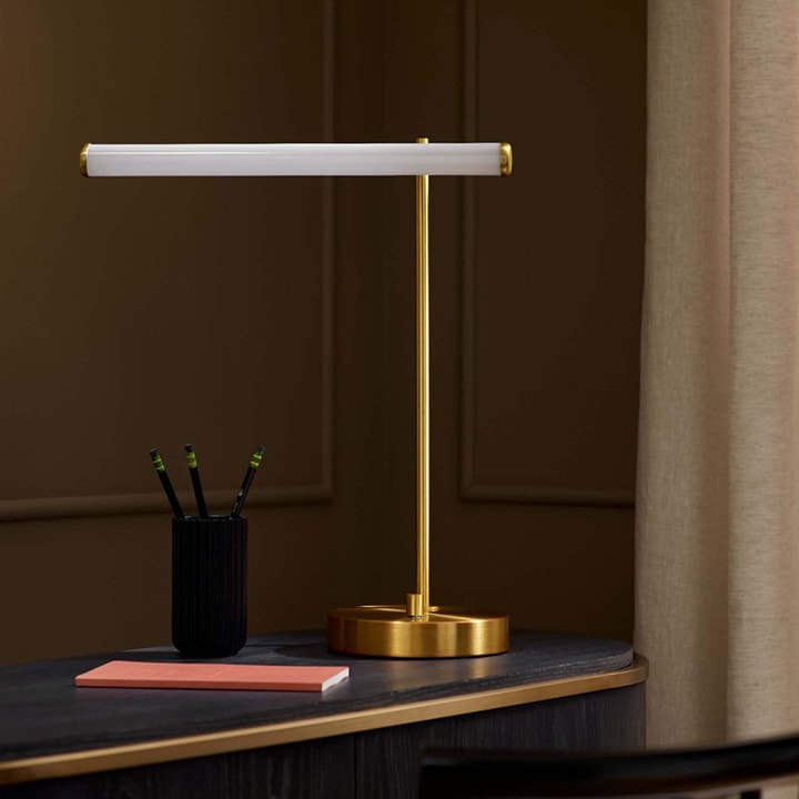 Desk with gold modern lamp.