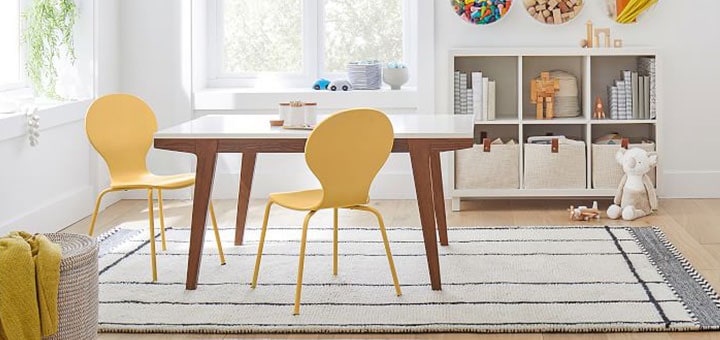 Wood mid-century table with yellow scoop play chairs