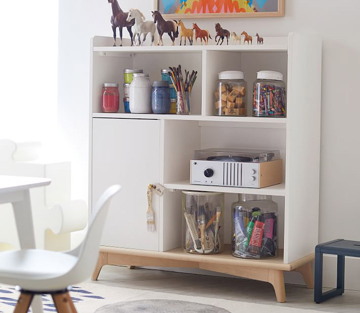 White bookshelf with toys and record player