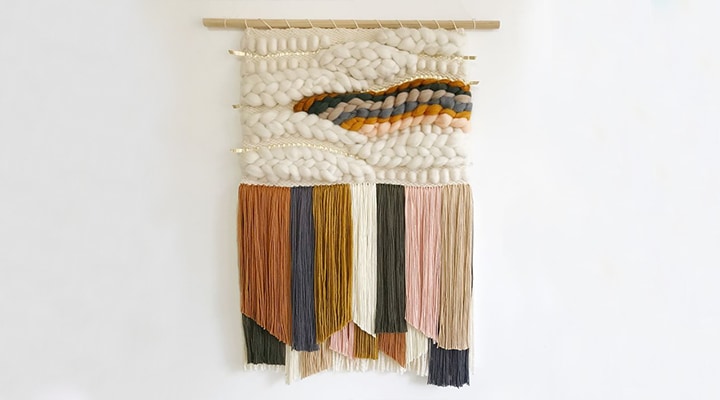 Woven yarn art hanging on wall