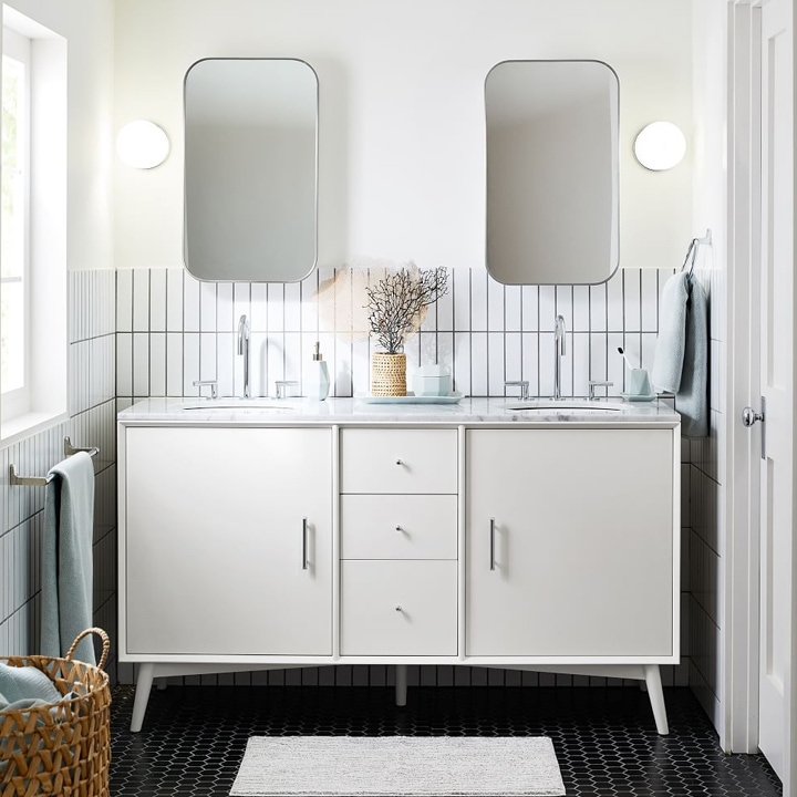 Bathroom with large double sink white vanity and black floor tile