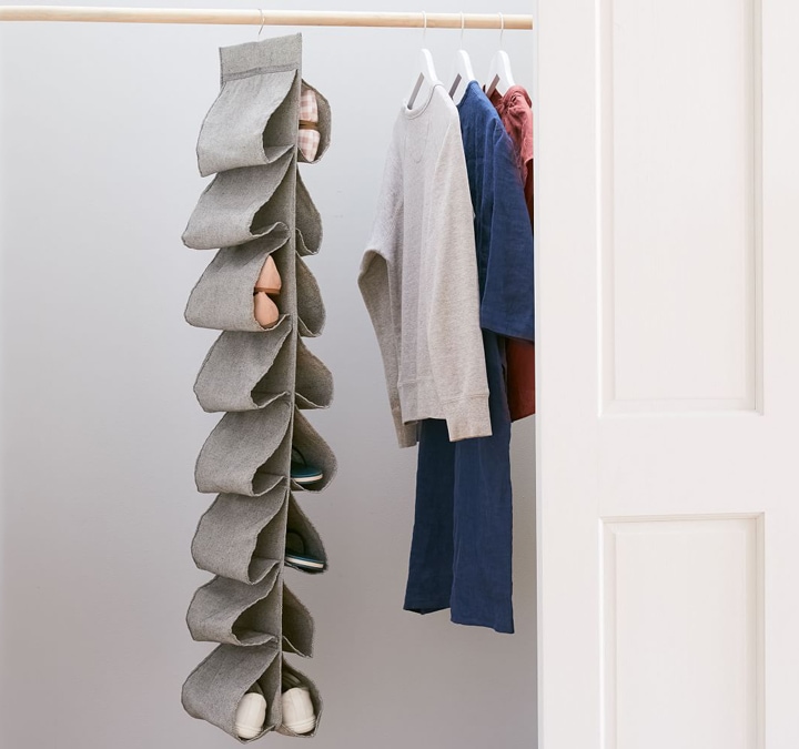 Gray hanging shoe holder in closet.