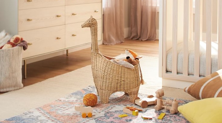 Giraffe shaped wicker basket holding toys