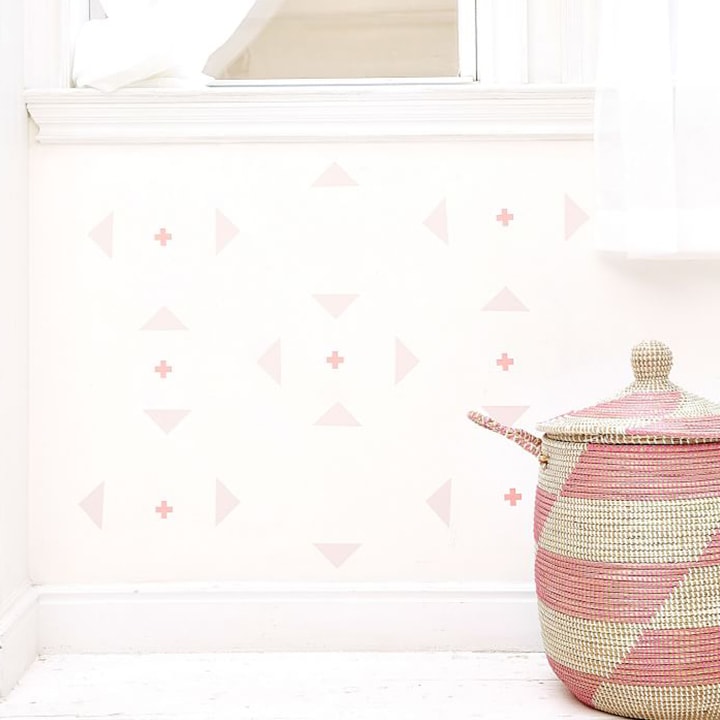 Wall with geometric decals and woven basket