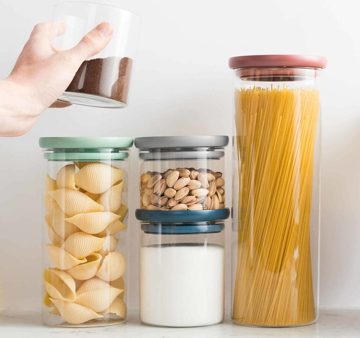 Storage jars with pasta, nuts and sugar.