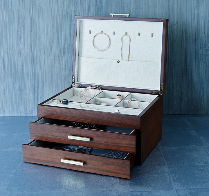 Wooden jewelry box with jewelry.
