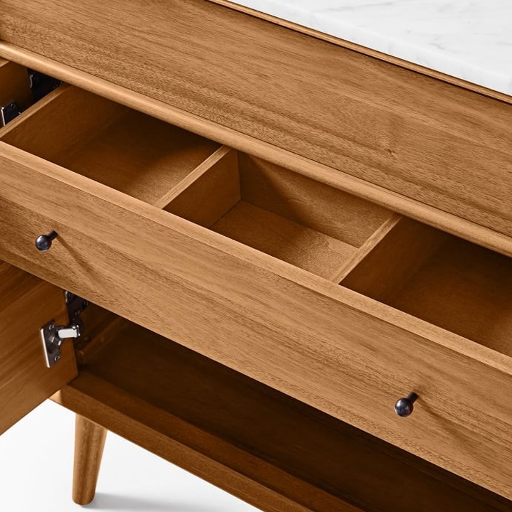 Close-up of open drawers on wood vanity