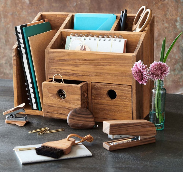 Wood desk organizer with notebooks and pens.