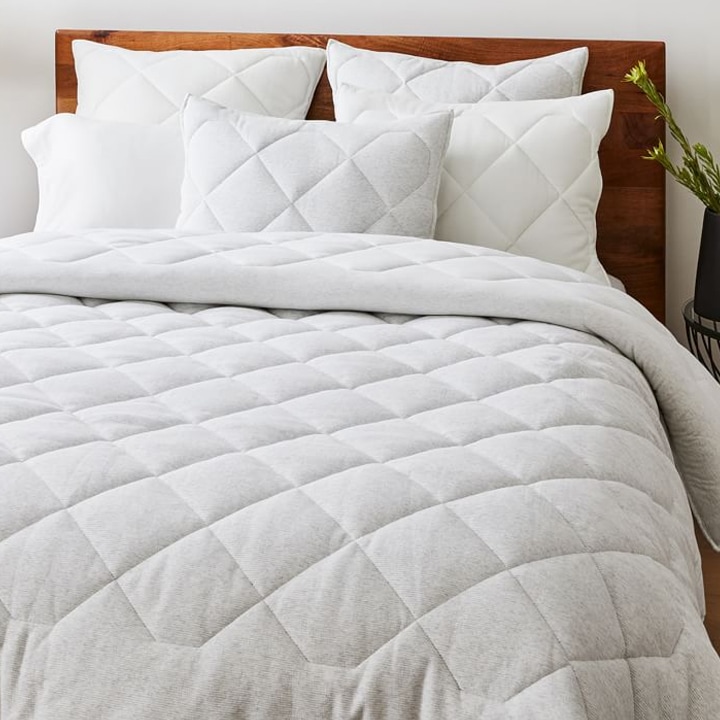 white cotton comforter and shams