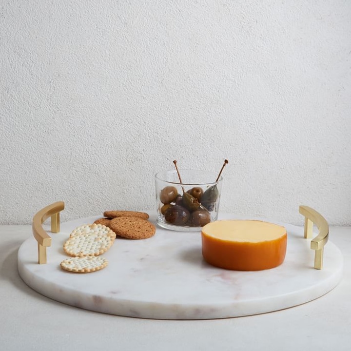 white marble cheese board with brass handles