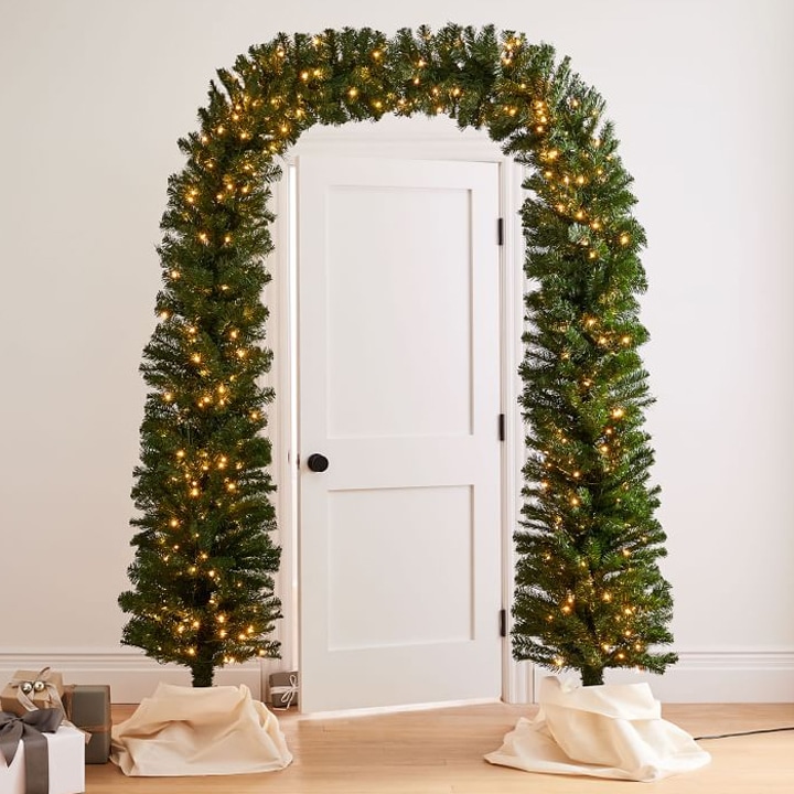 decorative arch made of pine boughs and lights