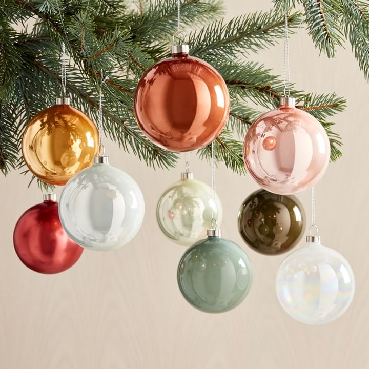 colorful round ornaments hanging from christmas tree