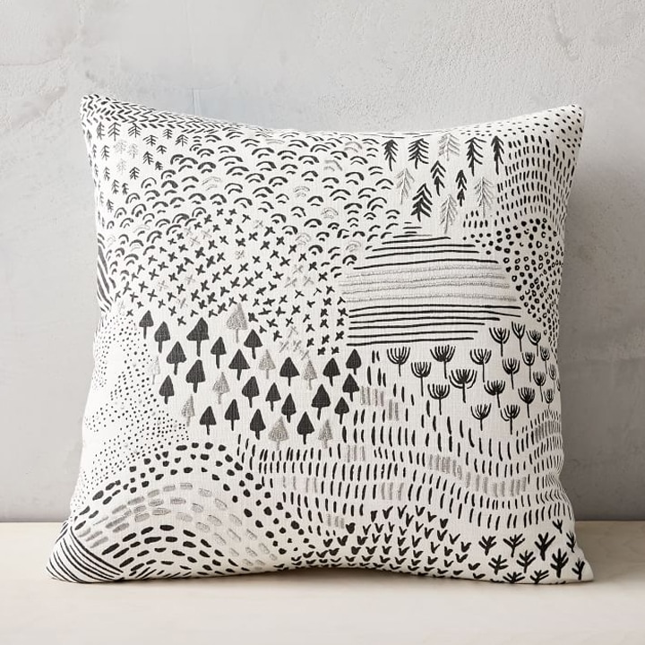 white and black patterned pillow