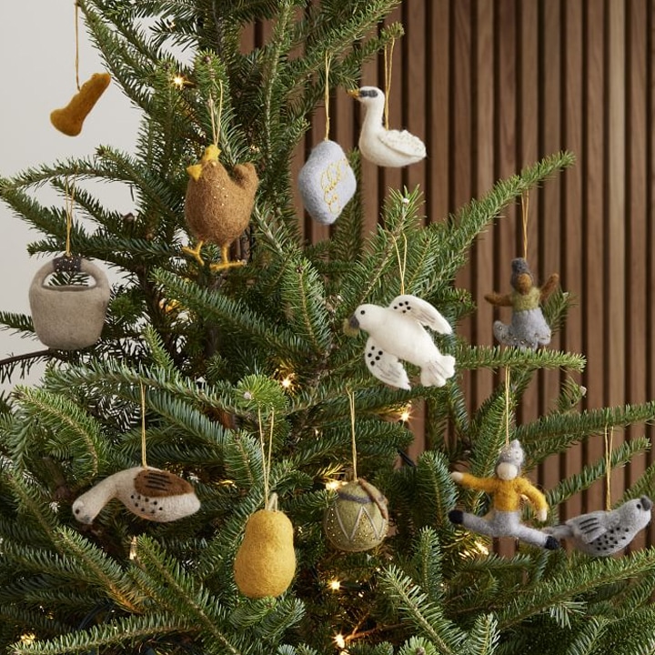 felted ornaments hanging from a christmas tree