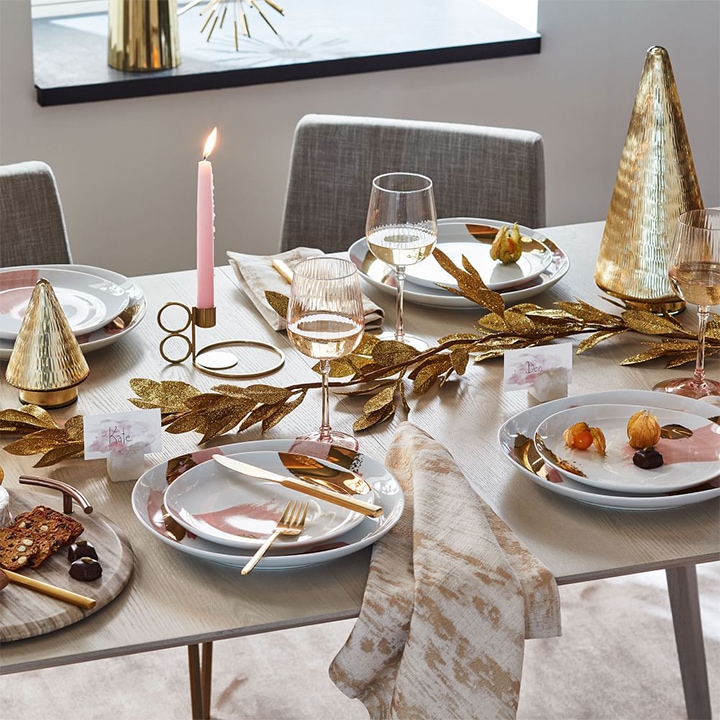Gold decorations and place settings on table.