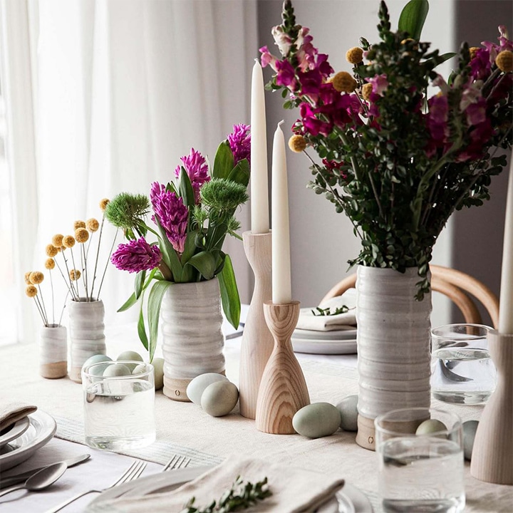 Flowers in pottery vases in the middle of the table.