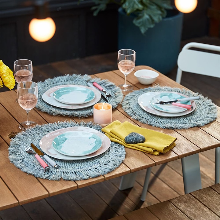 Placed table with woven rattan placemats.