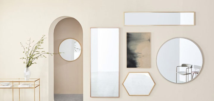 Mirrors on wall next to arch doorway.