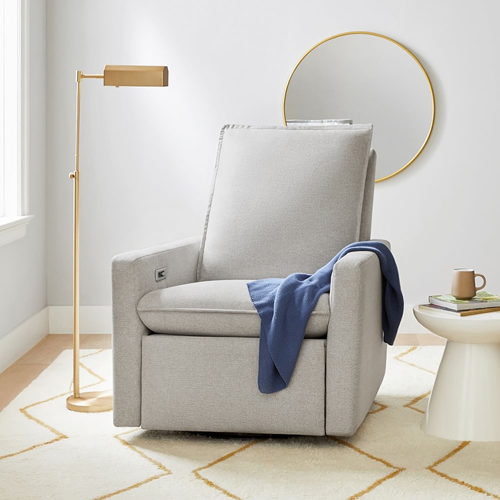 gray armchair with brass floor lamp