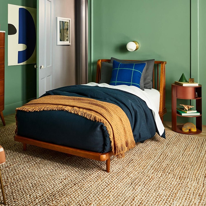 green walled bedroom textured rug