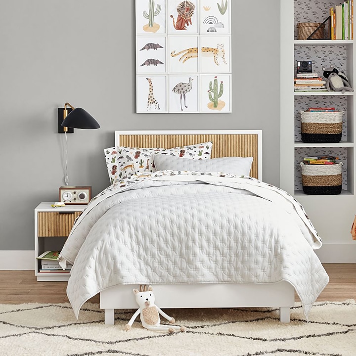 white quilt bedding animal artwork