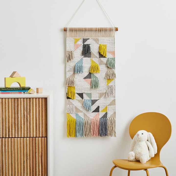 Multicolor quilt tapestry hanging on a wall