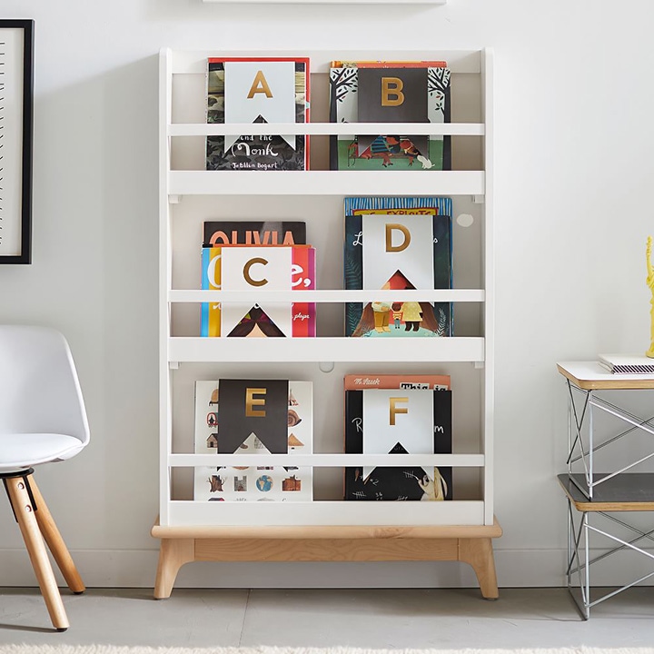Three-tier bookshelf holding children’s books