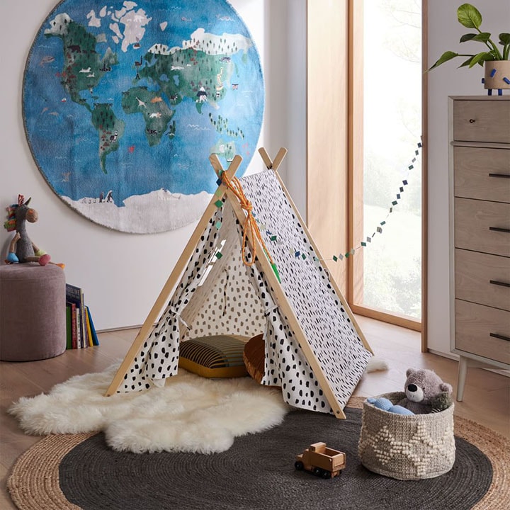 Small patterned tent with pillows and rugs