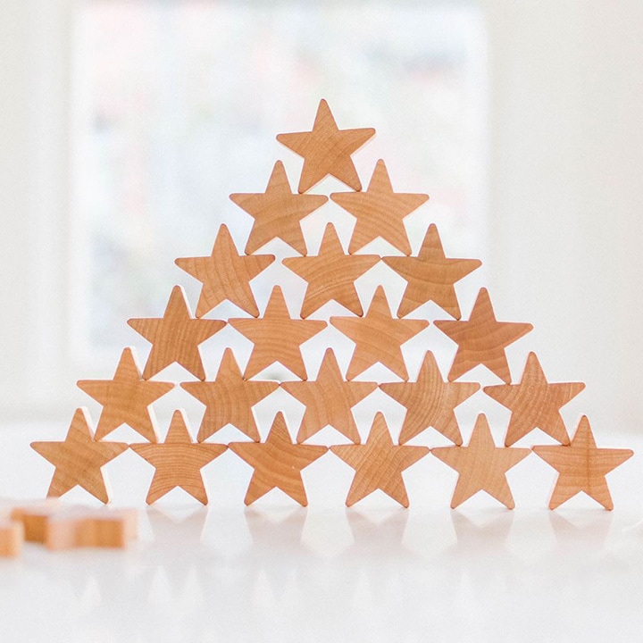 Wooden star-shaped toys placed on top of one another to form a pyramid