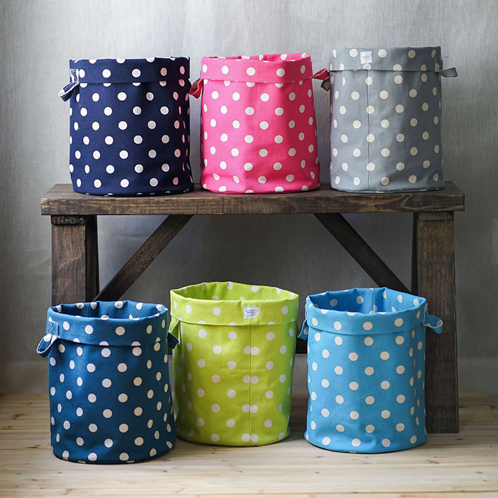 Six polka dot storage bins in various colors