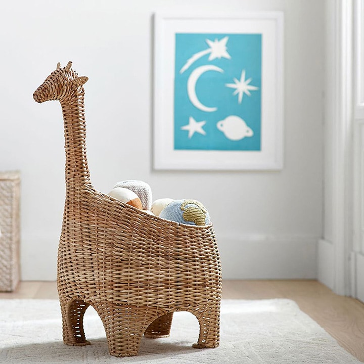 Giraffe-shaped wicker basket holding toys