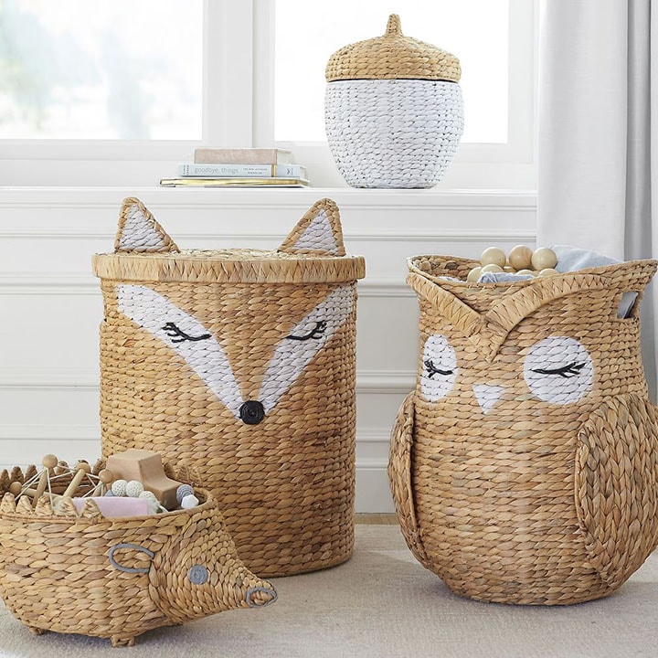 Four wicker storage baskets in the shape of a hedgehog, fox, owl and nut