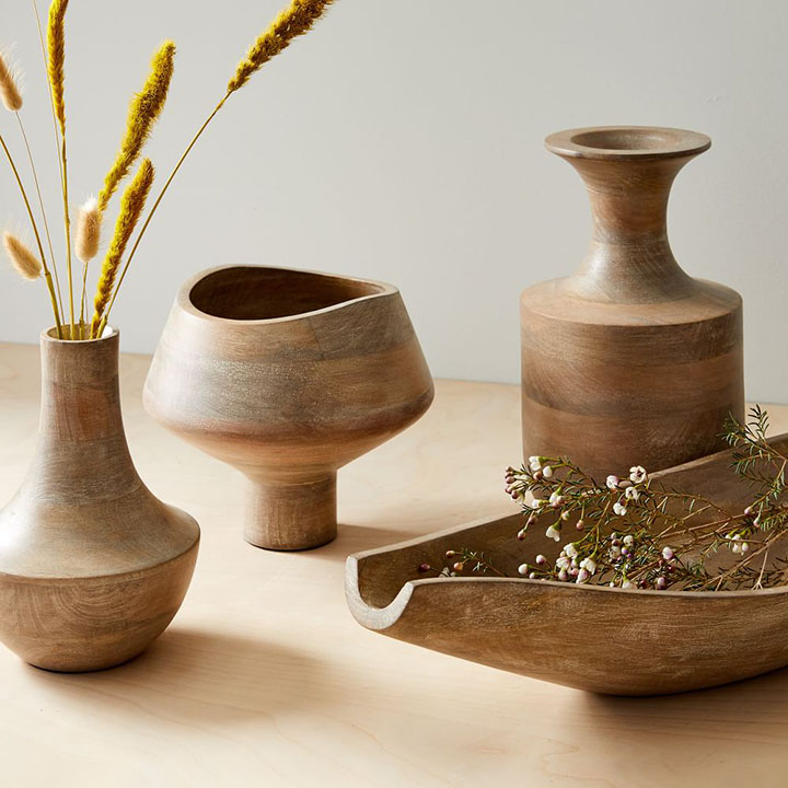 Four rustic wood decorative vases.