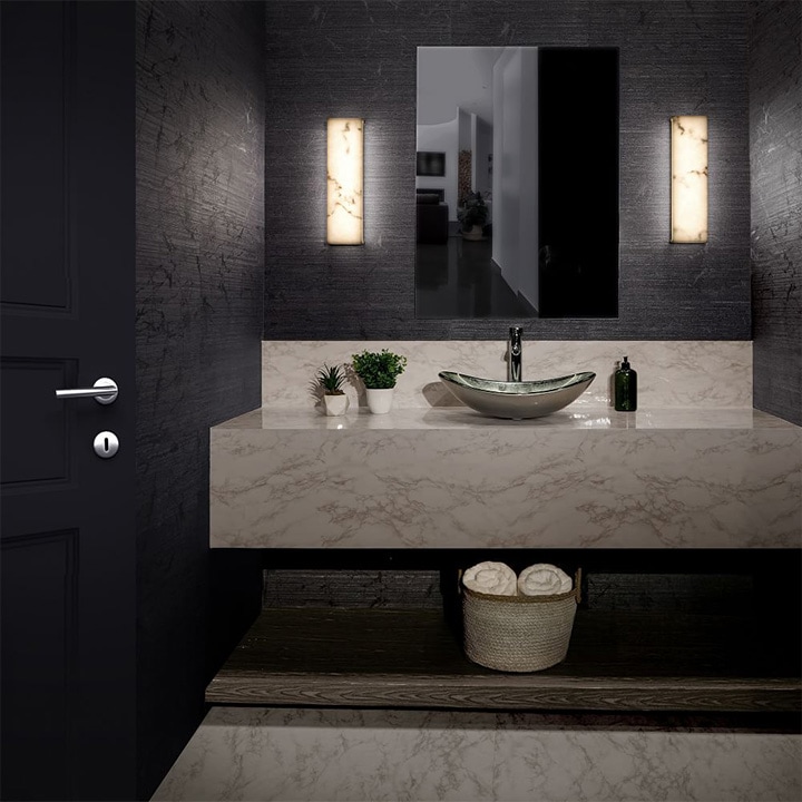  Two linear wall sconces with a marbled finish in a black bathroom.