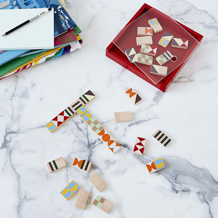 Colorful dominos laid out on marble table.