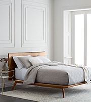 wooden platform bed with gray bedding 