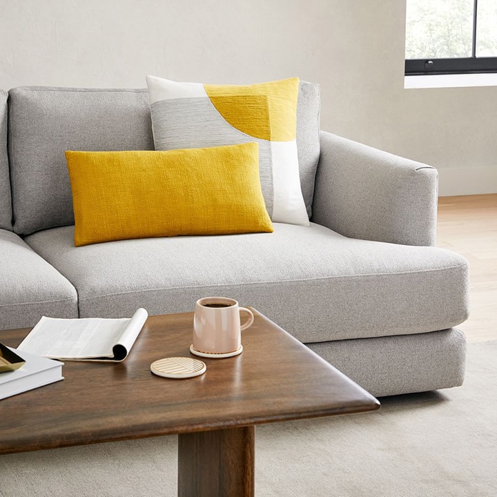Gray sofa with sunflower yellow throw pillows.