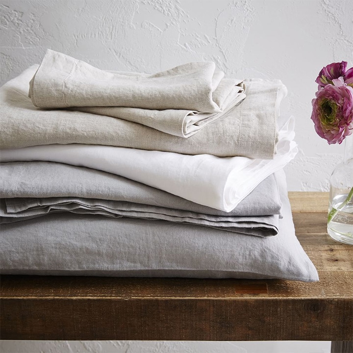 Pile of gray linen sheets.