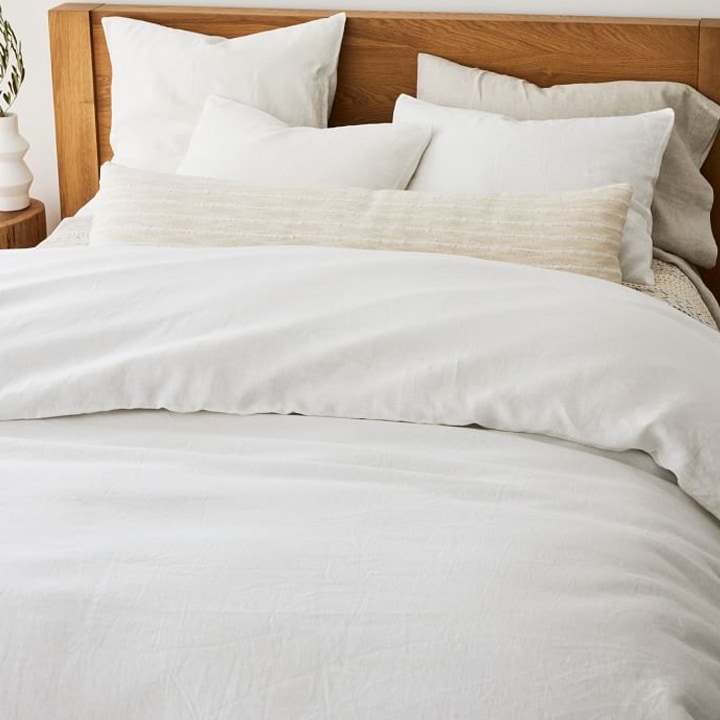 white bedding with long off white sham