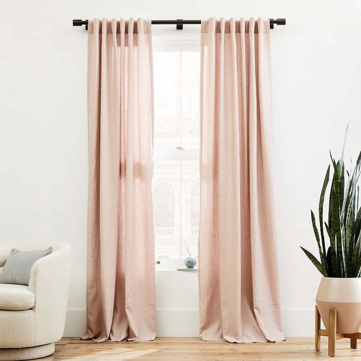 White airy room with rose-colored curtains